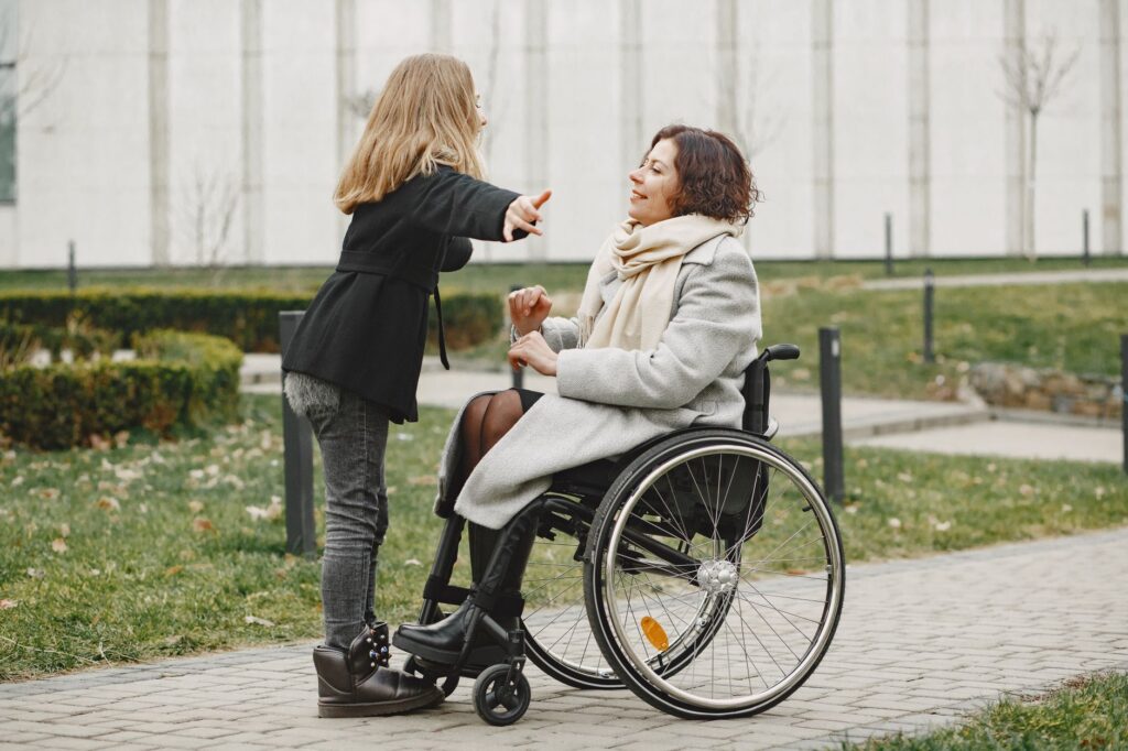 A mother who uses a wheelchair shares a joyful moment with her daughter
